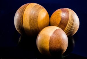 Stunning close-up of wooden balls with natural textures on a dark surface.